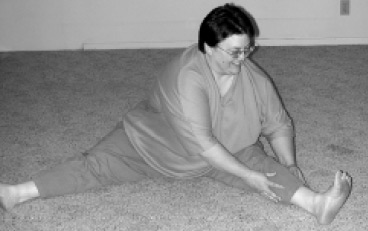 Yoga pose with legs stretched wide apart on floor