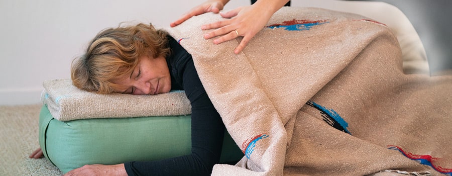 Yoga for Renewal Retreat ladies in childs pose with blankets