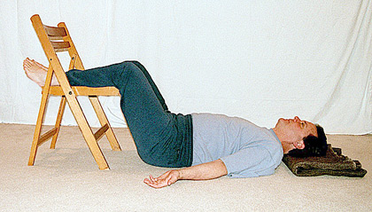 Student with lower legs up on a chair