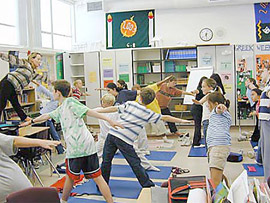 Middle school children practicing meditation in a classroom