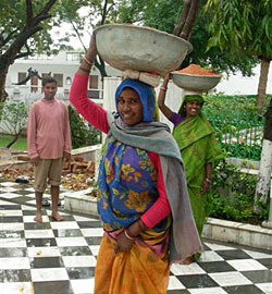 girl carrying basket on her head