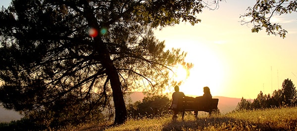 Guests sitting on a bench at Sunset Ridge, Ananda Village